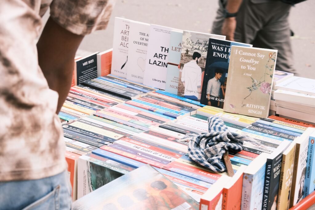 Mengapa "Kebodohan" Adalah Investasi Terburuk Menuju Indonesia Emas 2045? Vibrant outdoor book market scene in Bengaluru featuring diverse book collection.